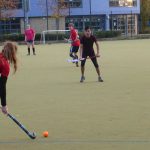 Women playing hockey