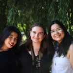 three students smiling